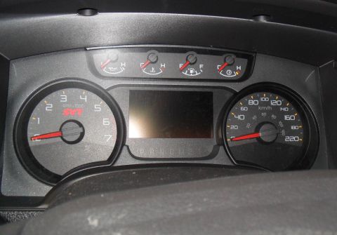 2011 Ford F-150 - Close-up of the SVT tachometer and speedometer gauges within a truck's interior.