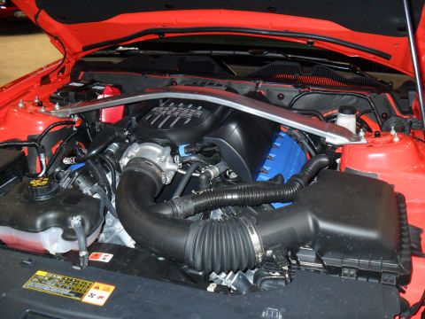 2012 Ford Mustang - Engine bay of a 2012 Ford Mustang, showing the V8 engine and intake system.