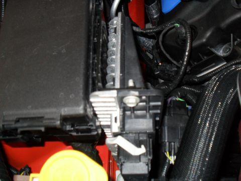2012 Ford Mustang - A detailed view of the electrical components and wiring within a vehicle's engine compartment.