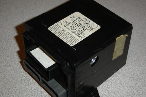 1996 Ford Bronco - A black Ford remote keyless entry module is shown, with a label detailing its part number and FCC ID.