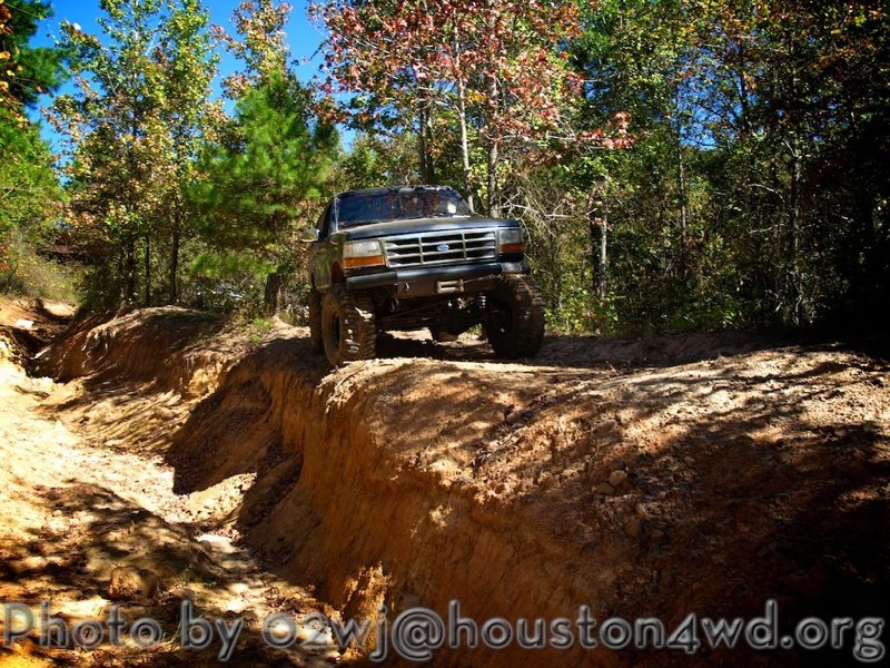 Ford Bronco driving on a dirt trail with steep sides