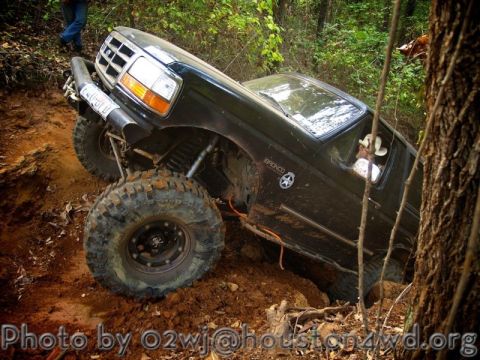 1995 Ford Bronco - This 1995 Ford Bronco is tackling a challenging off-road course with steep inclines and mud.