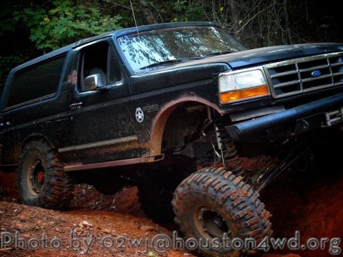 1995 Ford Bronco - This lifted 1995 Ford Bronco is navigating a challenging muddy off-road course.