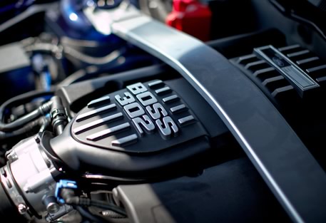 2012 Ford Mustang - The engine bay of a Ford Mustang Boss 302, highlighting the distinctive 'BOSS 302' engine cover.