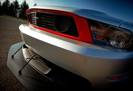 2012 Ford Mustang - Front view of a 2012 Ford Mustang Boss 302, showing its distinctive grille and red trim.