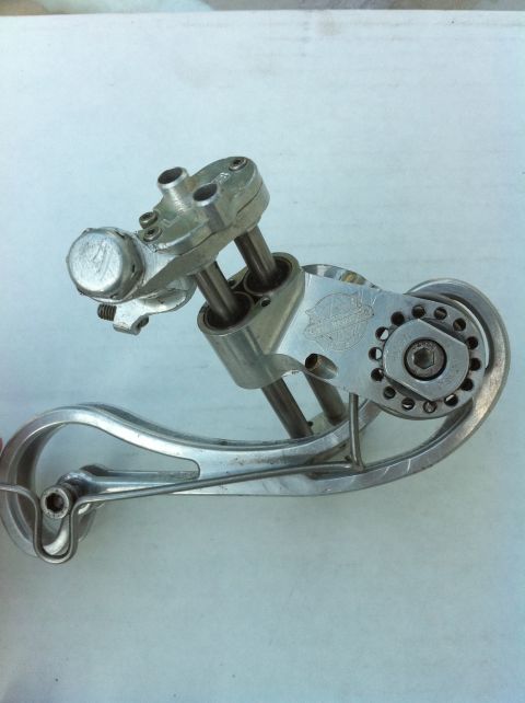 2010 Hyundai Genesis - A close-up view of a silver bicycle rear derailleur, its intricate mechanical components and pulley system.