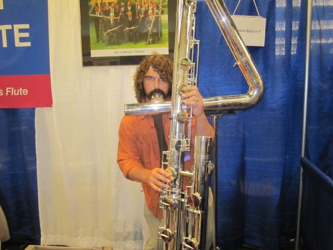 1990 Ford Bronco - A man plays a very large contrabass flute at an event.