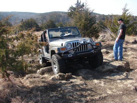 2005 Jeep Wrangler - Silver 2005 Jeep Wrangler Rubicon navigating a rocky trail with a person observing.