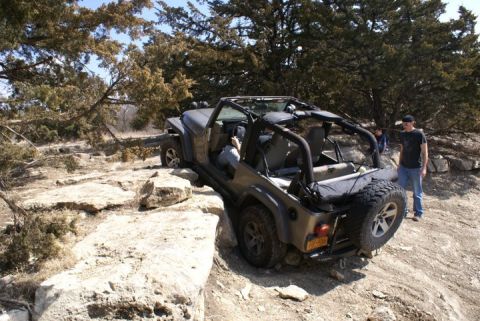2005 Jeep Wrangler - A Jeep Wrangler tackles a challenging off-road course on a sunny day.