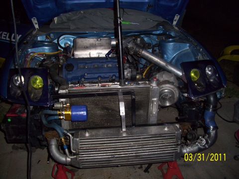 1995 Ford Probe - Customized engine bay a turbocharger and intercooler, with the hood open.