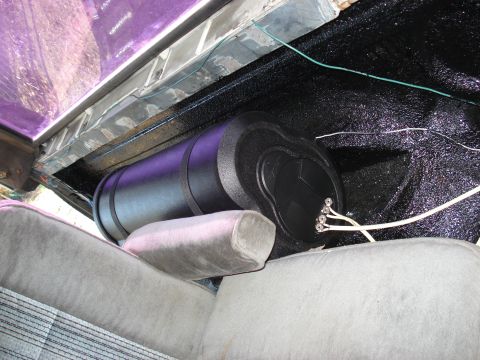 1992 Ford C-350 (Centurion Conversions) - Custom audio equipment installed in the rear of a vehicle, near the wheel well.