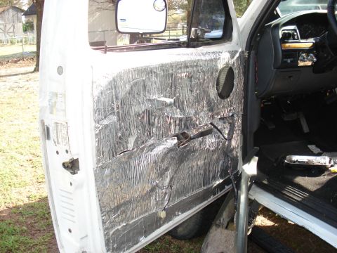 1992 Ford C-350 (Centurion Conversions) - Interior door panel of a truck covered in sound deadening material during a modification.