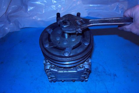 1996 Ford Bronco - Removing Pulley & Clutch. After removing the center bolt, drive in a 5/8" - 11 bolt to pull the assembly off the shaft. (8/26/2003)