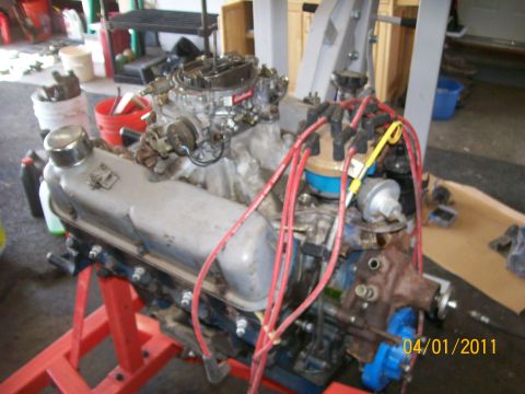 1970 Ford Bronco - Engine assembly with carburetor and distributor cap visible, mounted on an engine stand.
