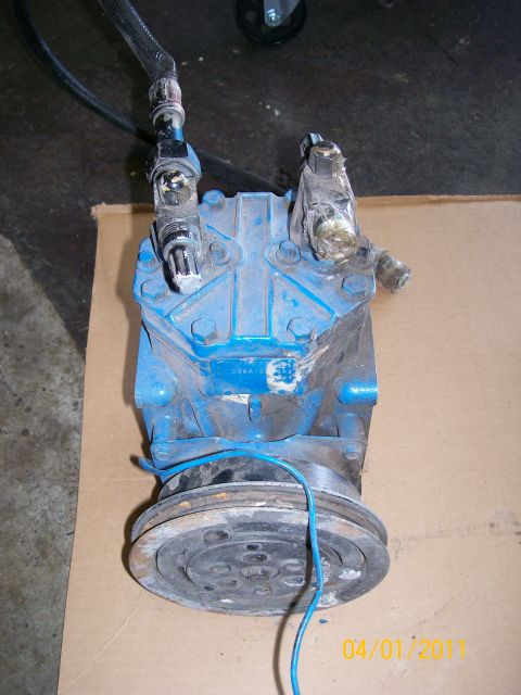1970 Ford Bronco - Blue air conditioning compressor with hoses and pulley, likely for an older vehicle. Registry claims 1970 Ford Bronco, but this is a part.