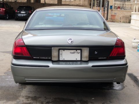 2001 Mercury Grand Marquis - This silver sedan features a rear view with a Kuwaiti license plate and Mercury badging, suggesting it is not a 2001 Mercury Grand Marquis.