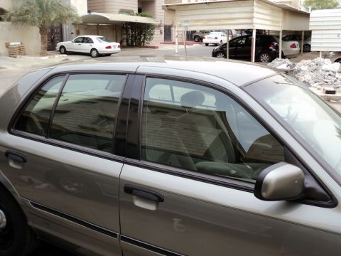 2001 Mercury Grand Marquis - A silver 2001 Mercury Grand Marquis is parked in a lot with other vehicles visible.