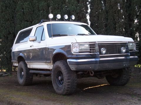 1989 Ford Bronco - Modified 1989 Ford Bronco with off-road tires and roof-mounted lights.