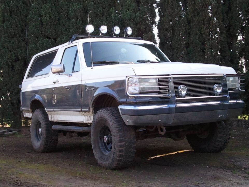 1989 Ford Bronco, two-tone paint, off-road tires, light bar on roof