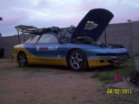 1995 Ford Probe - This 1995 Ford Probe is partially covered and has its hood open, showing its racing livery.