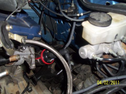 1995 Ford Probe - Engine bay detail showing brake fluid reservoir and ignition coil with visible date stamp.