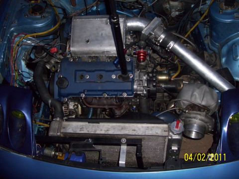 1995 Ford Probe - The engine bay shows a custom turbo setup with various hoses and piping.