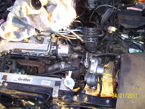 1995 Ford Probe - Close-up of a modified engine bay a turbocharger and custom components.