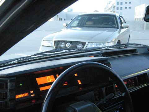2000 Mercury Grand Marquis - View of a 2000 Mercury Grand Marquis from the interior of another vehicle.