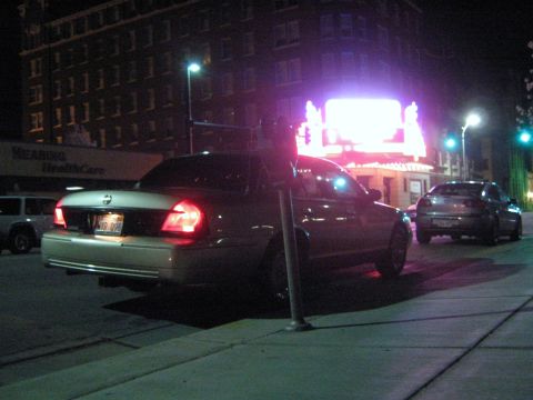 2000 Mercury Grand Marquis - Rear view of a 2000 Mercury Grand Marquis parked on a city street at night.