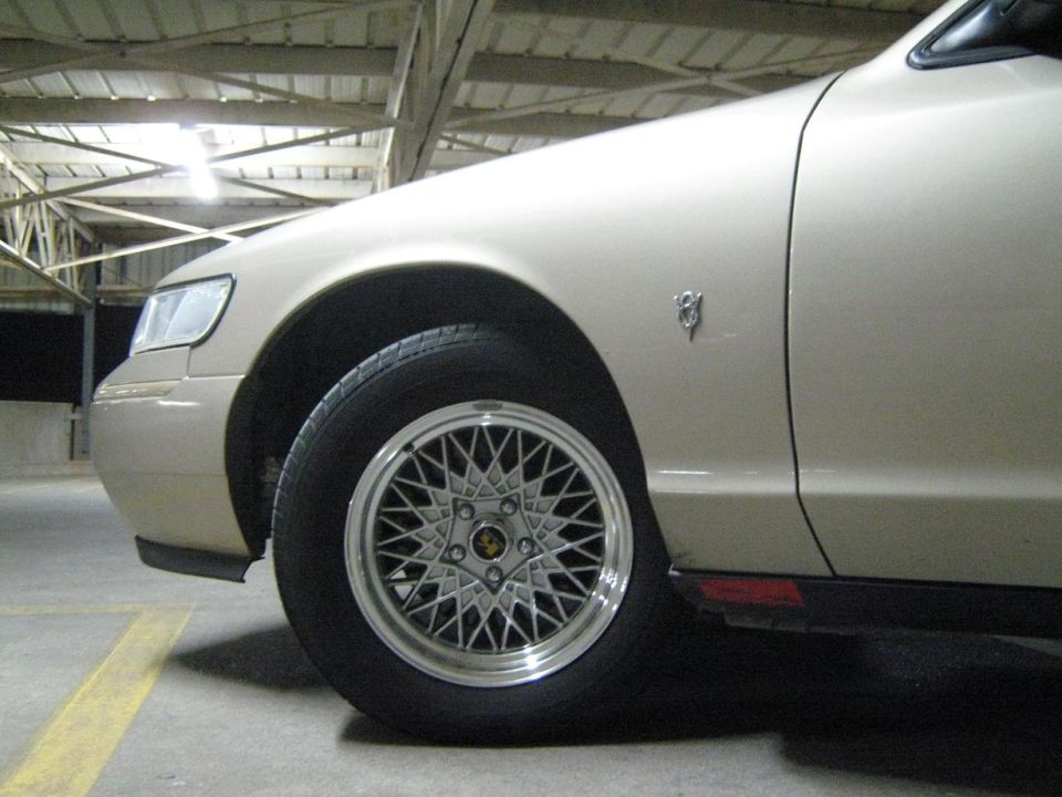 Tan 2000 Mercury Grand Marquis 3q-front view showing fender badge and mesh wheels