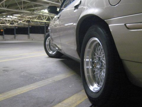 2000 Mercury Grand Marquis - Side profile of a tan 2000 Mercury Grand Marquis, wire wheels and a tan exterior.