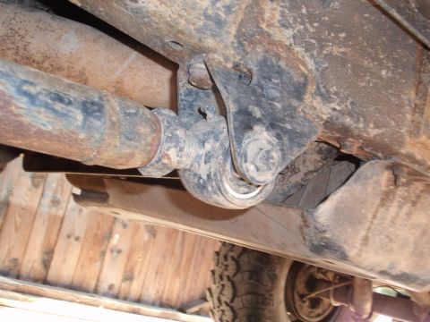 1996 Ford Bronco - Underside view of a vehicle's suspension system, showing a driveshaft and linkage.