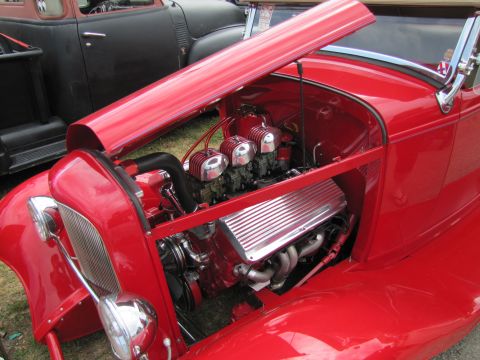 2006 BMW 5 Series - Custom V8 engine with triple carburetors is visible in the engine bay of a red hot rod.