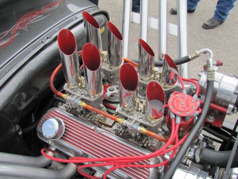2006 BMW 5 Series - Close-up view of a custom V8 engine with prominent exhaust pipes and red wiring.