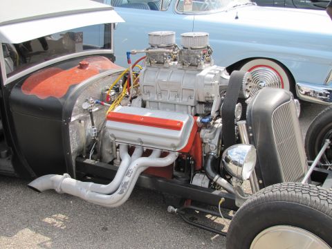 2006 BMW 5 Series - Custom hot rod engine a prominent supercharger and exhaust headers, with a classic car in the background.