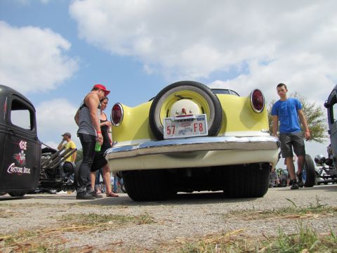 2006 BMW 5 Series - Rear view of a 1957 Ford Fairlane at a car show, with other vehicles visible.