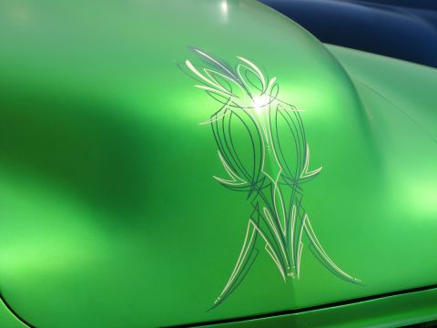 2006 BMW 5 Series - A green car hood displays custom pinstripe artwork.