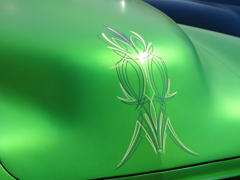 Green car hood with pinstripe graphics, close-up view