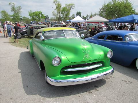 2006 BMW 5 Series - A custom green coupe with a yellow roof and pinstriping is parked next to a blue car at an outdoor event.