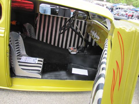 2006 BMW 5 Series - The interior of a custom yellow hot rod features striking black and white striped upholstery on the seats and rear panel.