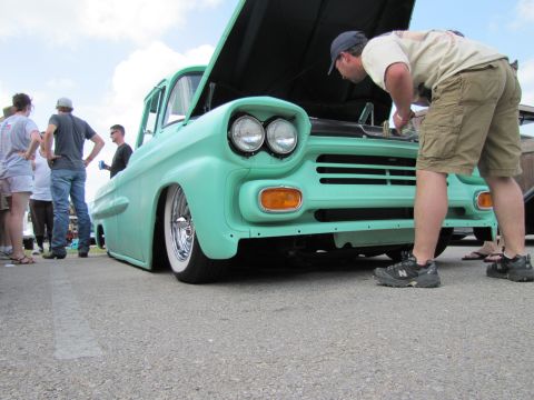 2006 BMW 5 Series - A mint green vintage truck is examined by onlookers at an outdoor event.