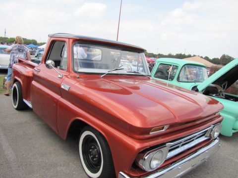2006 BMW 5 Series - This classic orange pickup truck features whitewall tires and a distinctive grille, seen at an outdoor event.