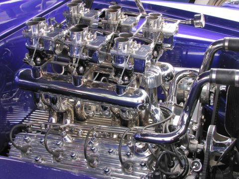 2006 BMW 5 Series - Detailed view of a highly polished V8 engine with multiple carburetors and chrome components.