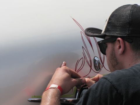 2006 BMW 5 Series - Custom pinstriping is being applied to a vehicle's exterior.