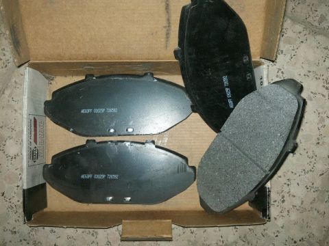 1998 Ford Crown Victoria - A box containing four brake pads, with visible part numbers and the NAPA logo on the side of the box.