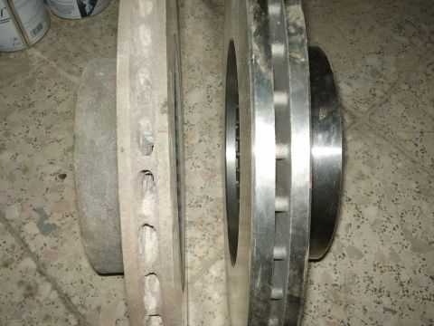 1998 Ford Crown Victoria - Comparison of a used brake rotor next to a new one.
