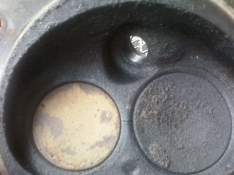 1990 Ford Bronco - This is a close-up view of an engine's cylinder head, revealing the intake and exhaust valve seats.