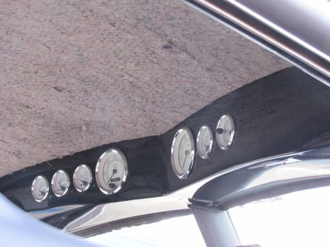 2006 BMW 5 Series - Multiple gauges are installed on the interior headliner of a vehicle.