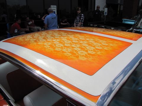 2006 BMW 5 Series - A close-up of a car's roof a unique orange and white flame-like paint design with floral accents.