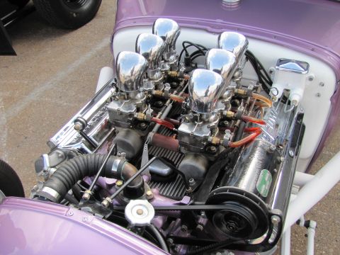 2006 BMW 5 Series - Close-up of a custom V8 engine with multiple carburetors and polished components.